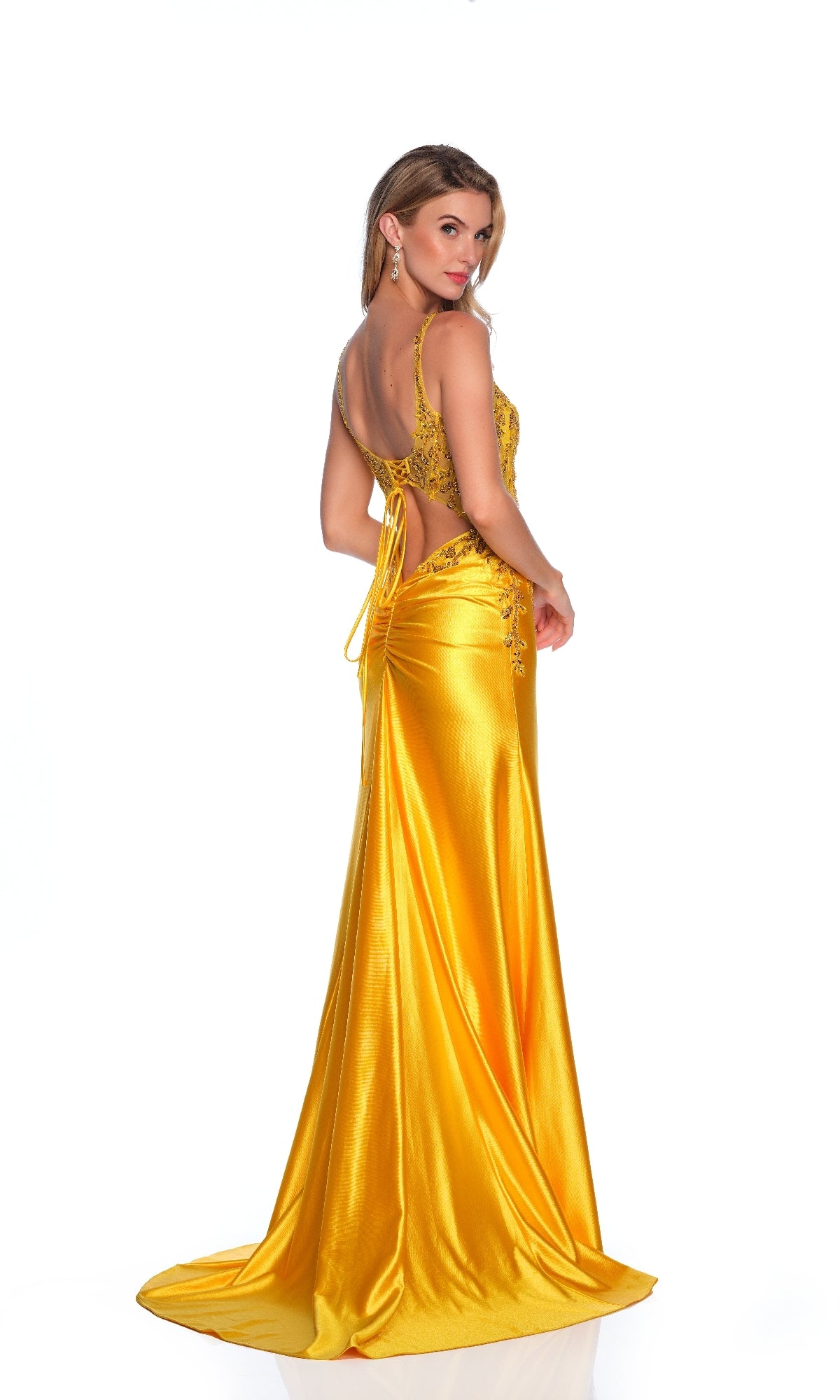 Woman wearing the Dave & Johnny 12132 long prom dress—backless, floor-length yellow satin with lace accents and a sparkly sheer bodice—posing against a white background.